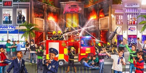 Kids dressed as firefighters participating in a firefighting activity at KidZania Dubai.