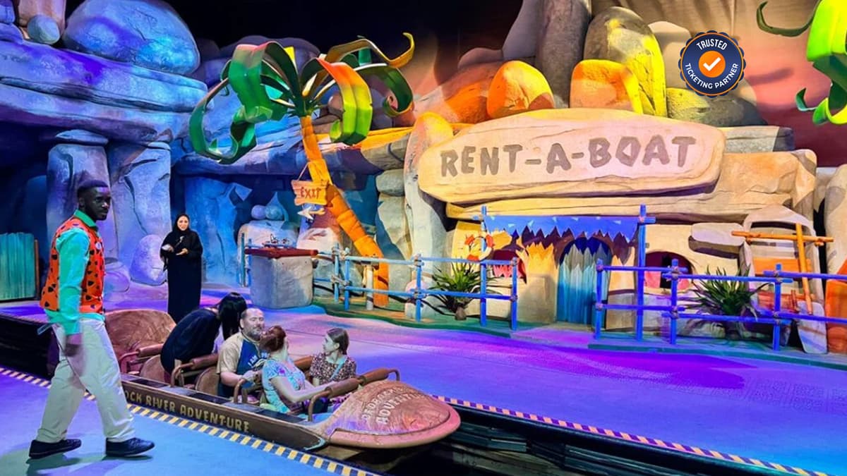 Visitors enjoying a themed boat ride attraction at Warner Bros. World Abu Dhabi.