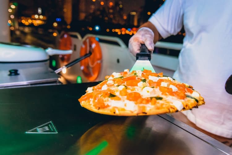 Fresh food being prepared at cooking station on mega yacht cruise