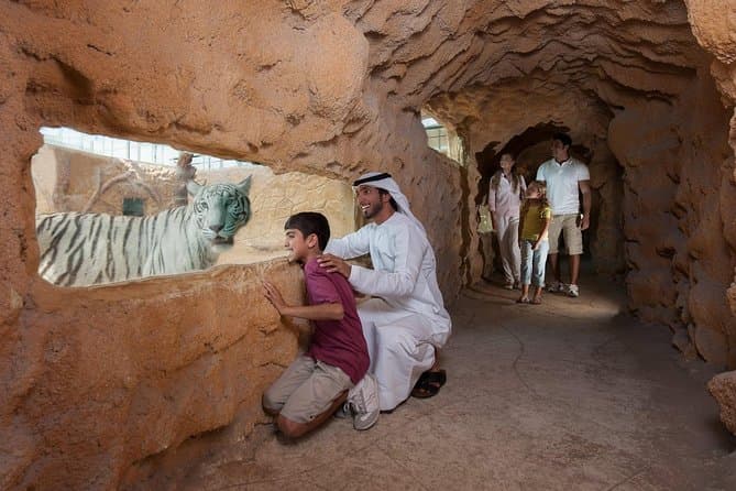 UAE local sharing cultural experiences with kids during a visit to Emirates Zoo Park.
