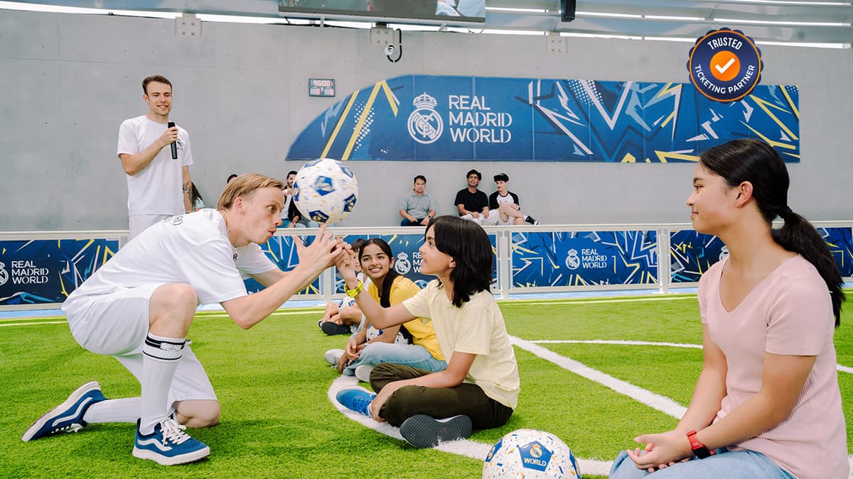 Kids receiving football training and practicing skills at Real Madrid World.