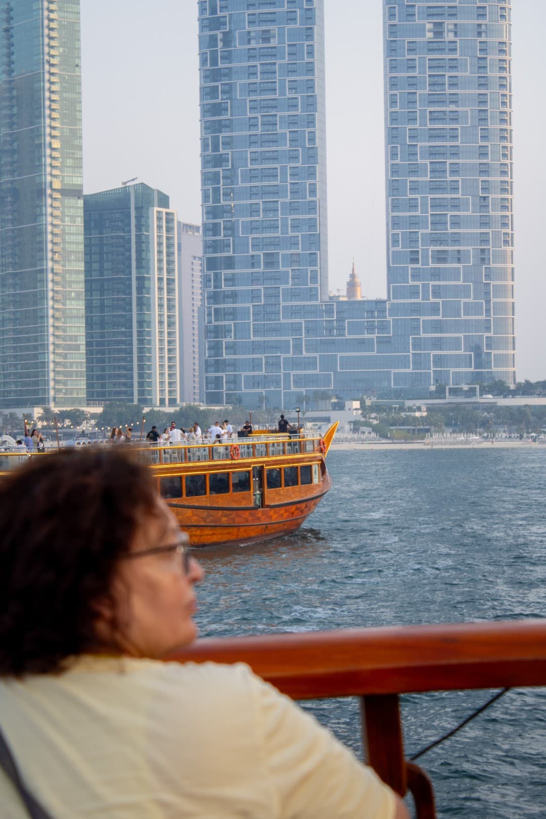 Passengers enjoying a sunset cruise on a dhow in Dubai Marina