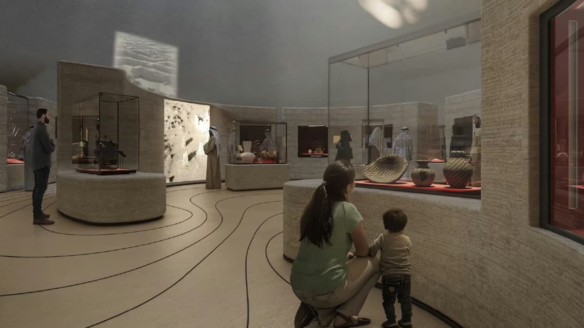 A woman and a child observe an exhibit in Zayed National Museum Abu Dhabi, engaged in learning about the displayed artifacts.
