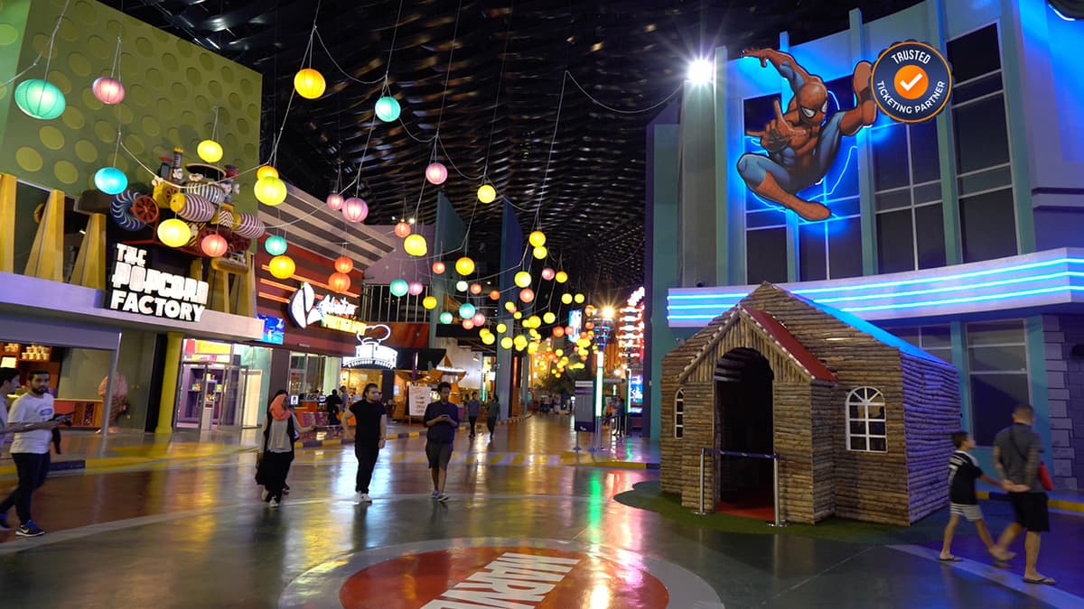 Visitors walking and exploring the themed zones inside Warner Bros. World Abu Dhabi.
