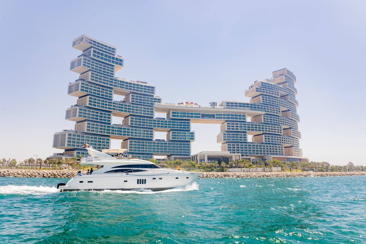 A boat glides through water near the Atlantis Royale building during the Burj Coastline Tour.