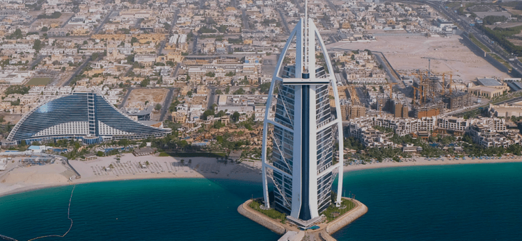 Burj Al Arab ariel view, seen from a private helicopter tour over the ocean.