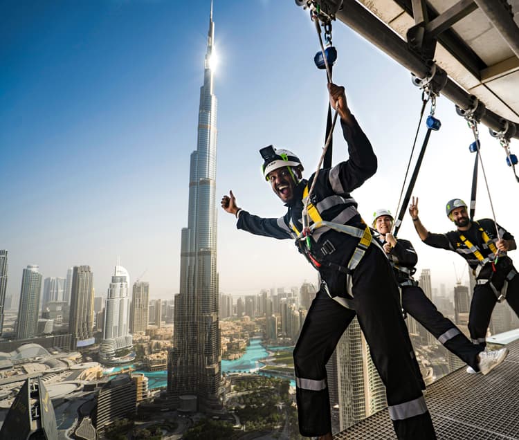 Visitor experiencing sky hanging at Sky Views Dubai while suspended high above the city skyline