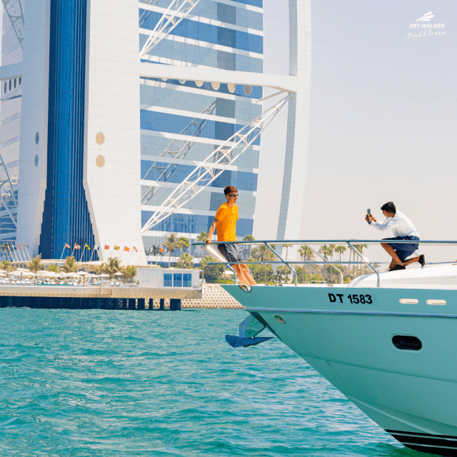A white boat gliding on water, captured from the front deck during the Burj Coastline Tour.