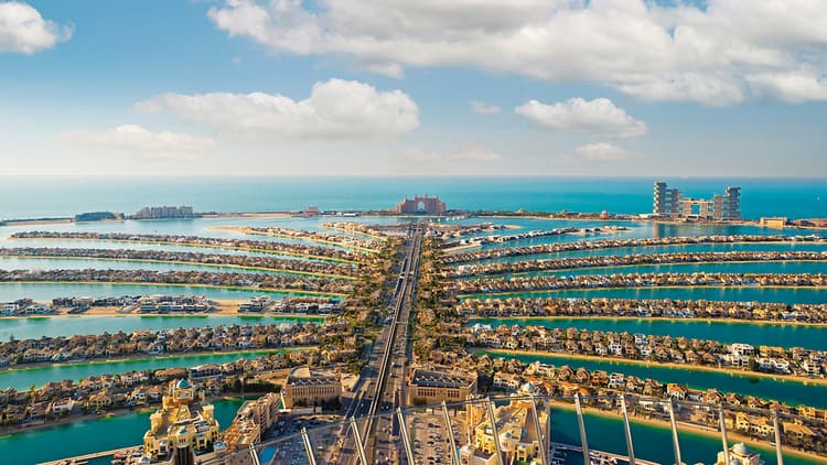 Palm Island in Dubai, UAE, showcasing its iconic palm tree shape and luxurious waterfront properties.