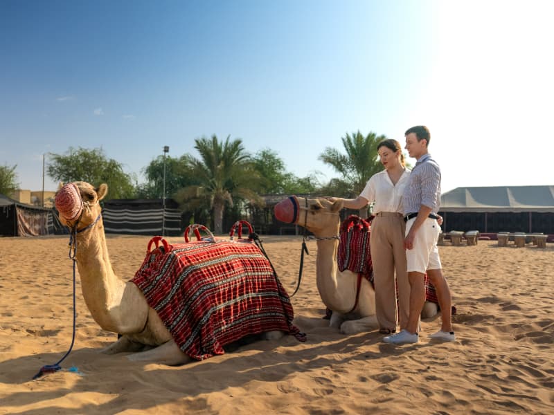Guest enjoying a camel ride in the desert during the Dubai hot air balloon experience