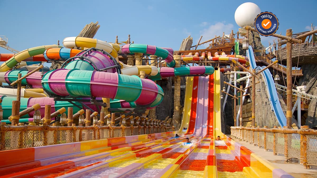 Guests enjoying thrilling water slides and rides at Yas Waterworld on Yas Island in Abu Dhabi.