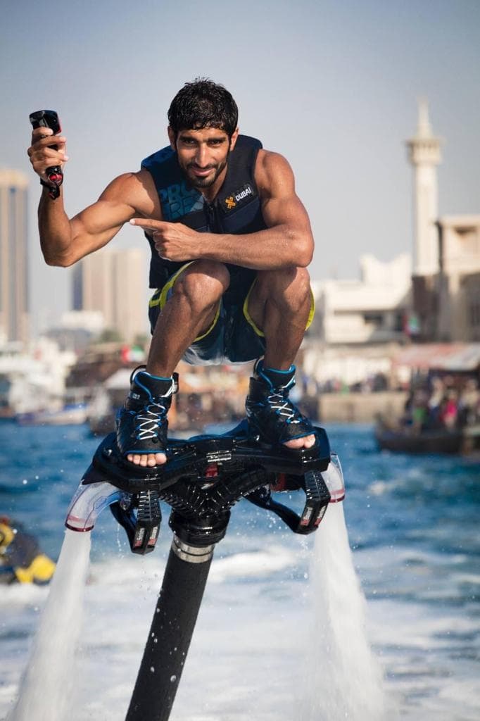 A man on a jet ski takes a selfie, capturing a moment at Flyboard Dubai.