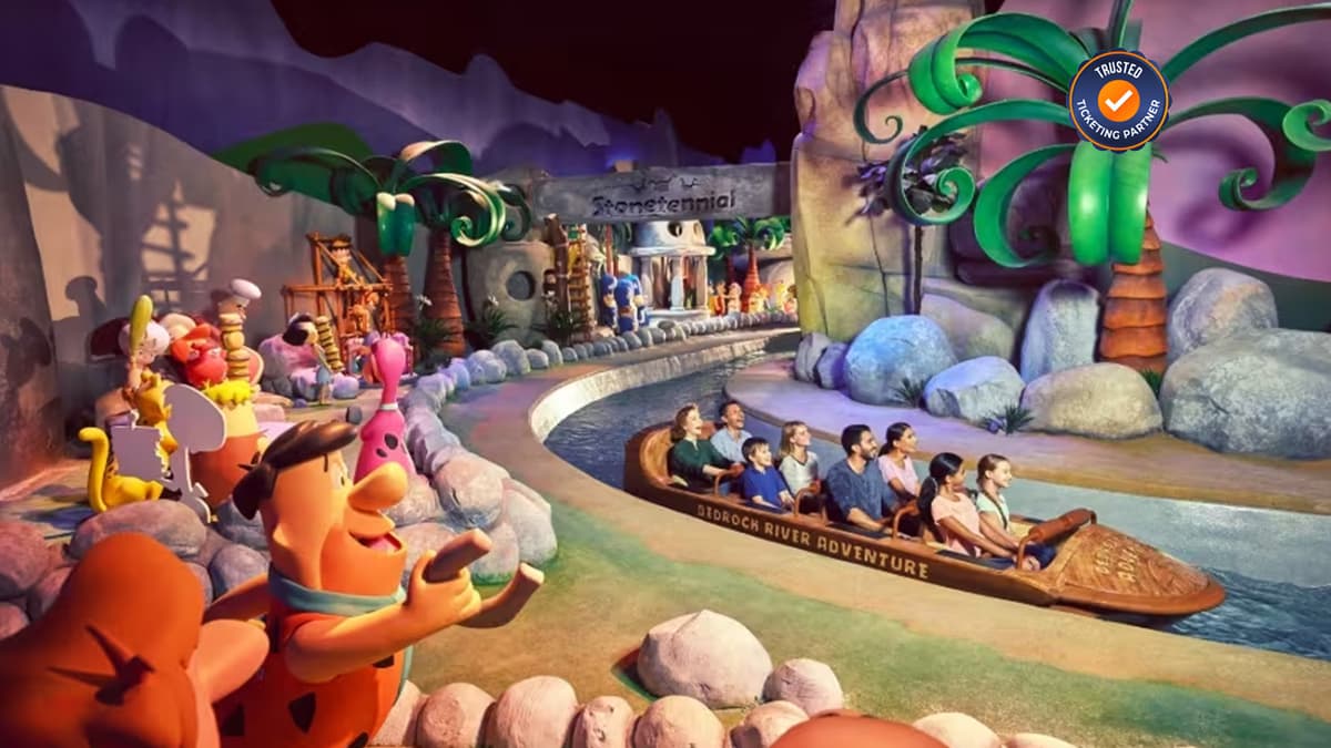 Group of people enjoying thrilling rides together inside Warner Bros. World Abu Dhabi.