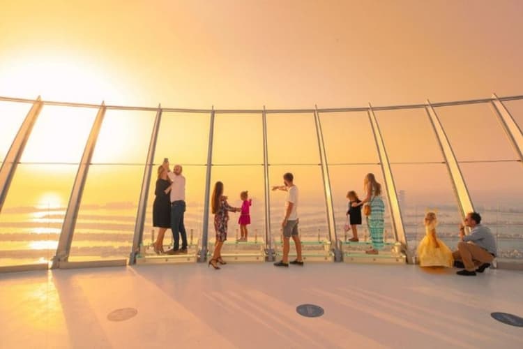 Visitors enjoying panoramic views of Palm Jumeirah from the observation deck at The View at The Palm.